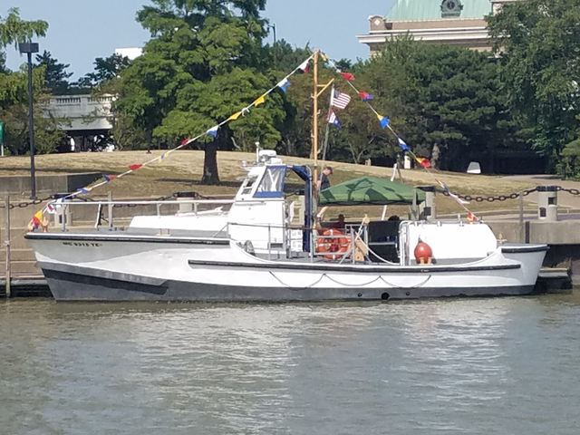 MLB 44334 afloat alongside a seawall, dressed with signal flags, full port-side profile