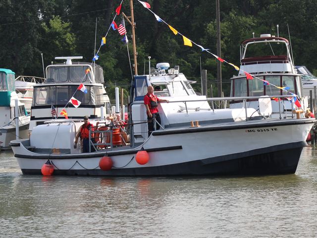 MLB 44334 moving through the water with signal flags strung from her mast