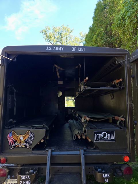 Rear doors of the M725 open, showing the litter racks inside