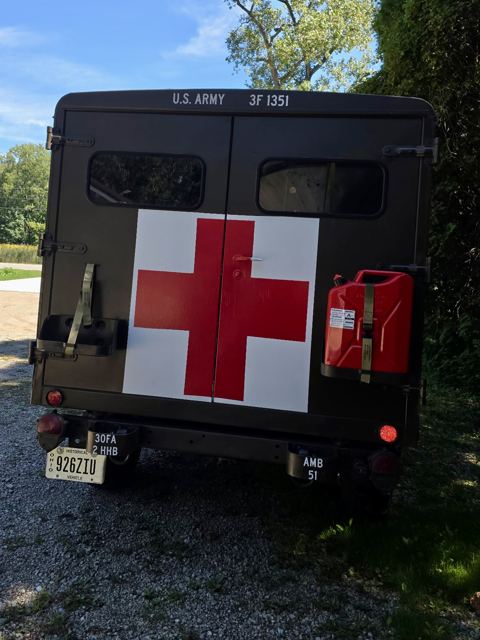 Rear doors of the M725 ambulance with the red cross and a jerry can mounted