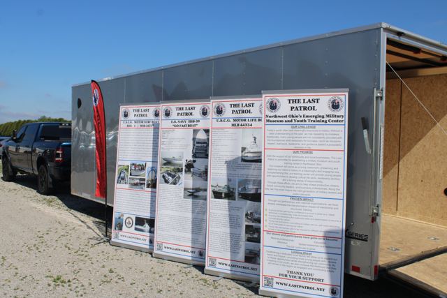 The mobile museum trailer open with display panels along the ramp