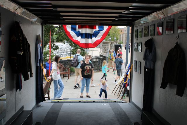 Families walking through the mobile museum trailer decorated with bunting
