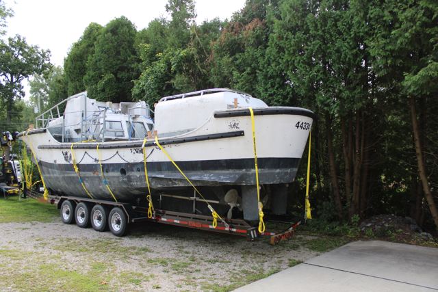MLB 44334 on her trailer parked among trees at her new home