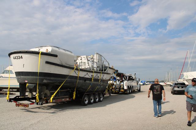 Heavy wrecker hitched to the trailer with the bow of 44334 behind it