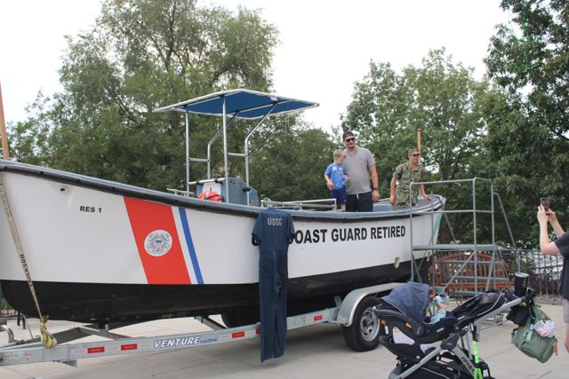 The surf boat RES 1 with a canopy rigged, on display at a community event