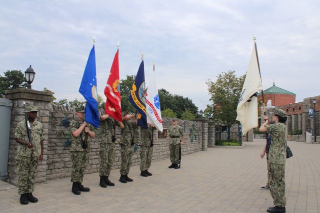 Sea Cadet color guard in working uniform presenting the colors