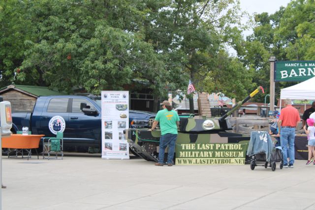 The Last Patrol display with the mobile museum trailer, Lil Abe and the surf boat at a public event