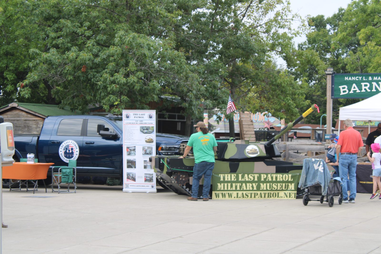 The Last Patrol traveling display at a public event: the Mobile Museum trailer, Lil Abe and the surf boat RES 1