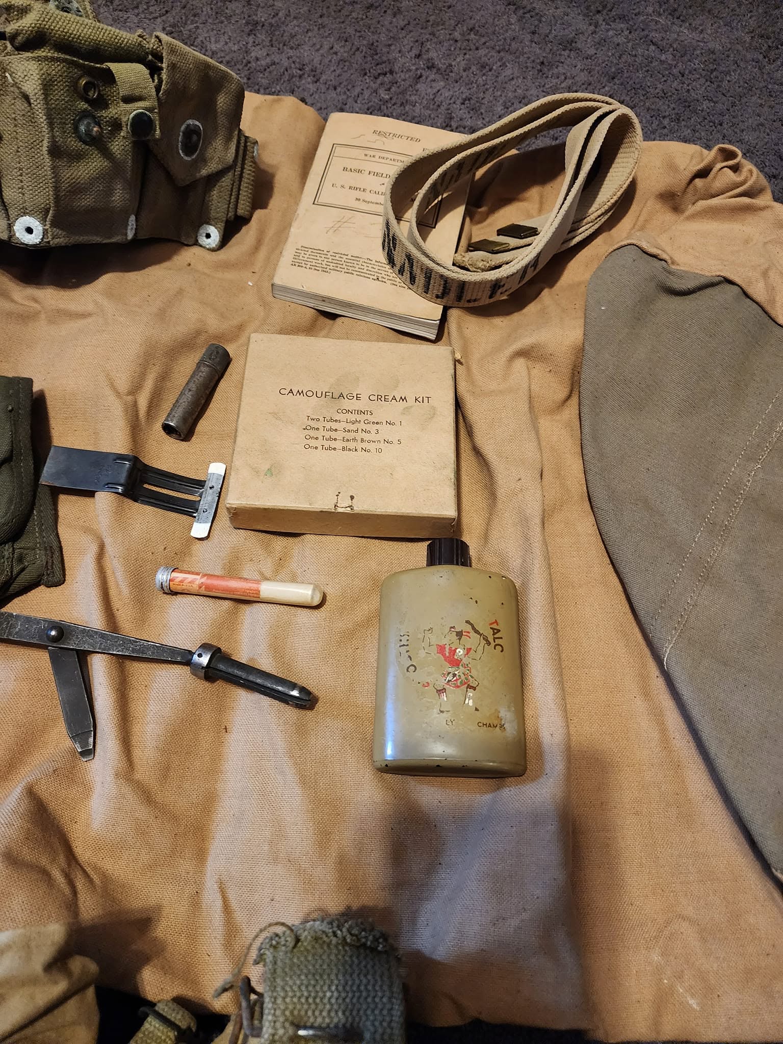 World War II field gear, manuals and personal equipment laid out for cataloguing