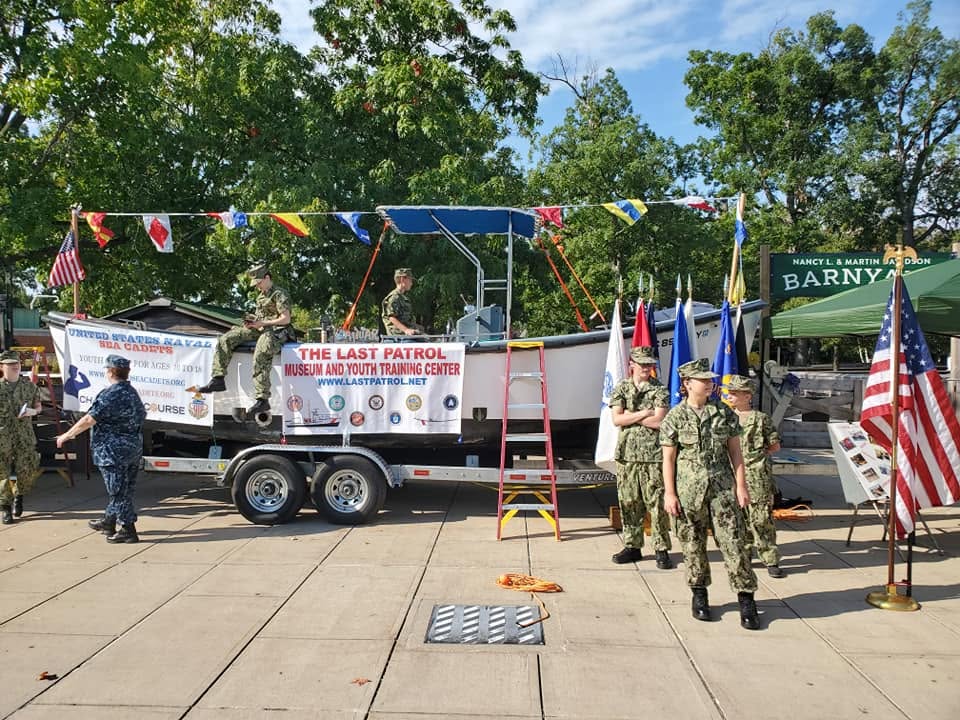 The 26-foot boat dressed with signal flags and Sea Cadet banners at a community event